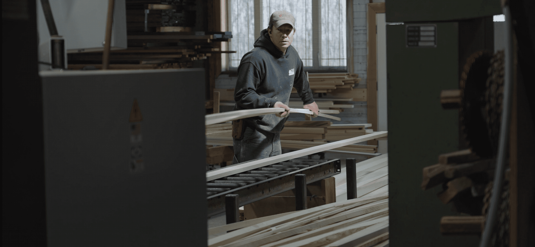 A man moving lumber