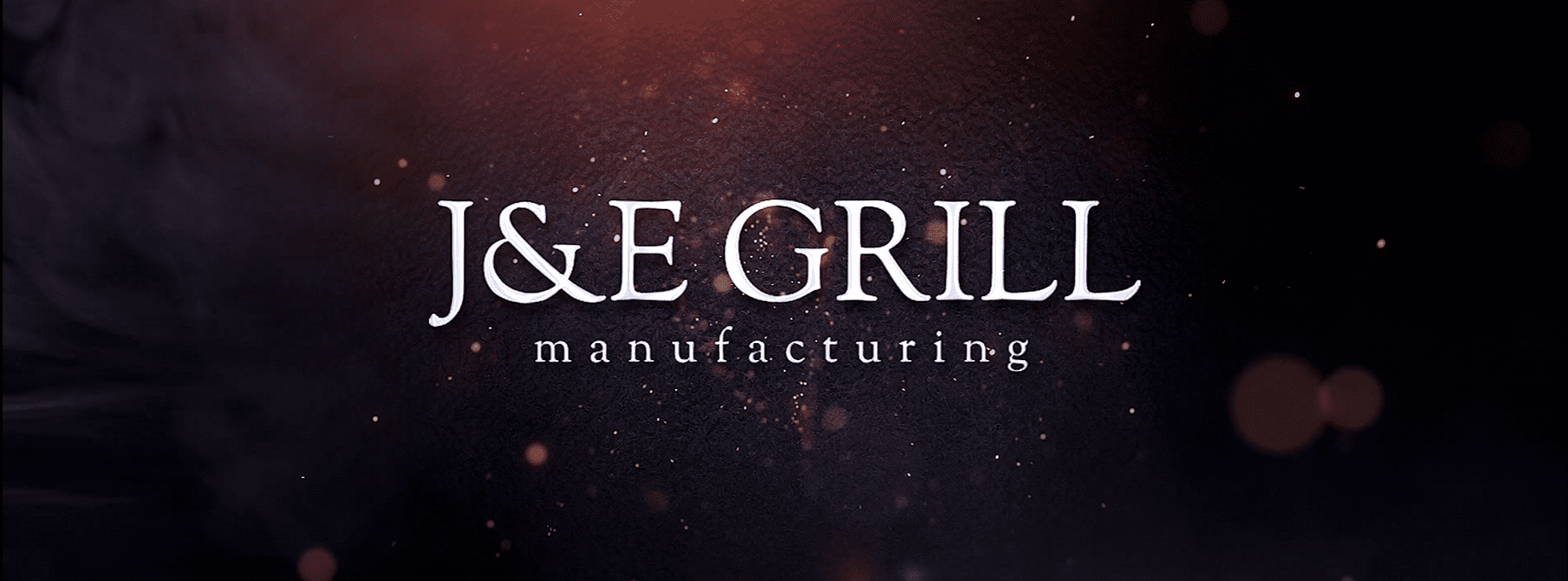 J&E Grill Manufacturing logo with sparks and smoke